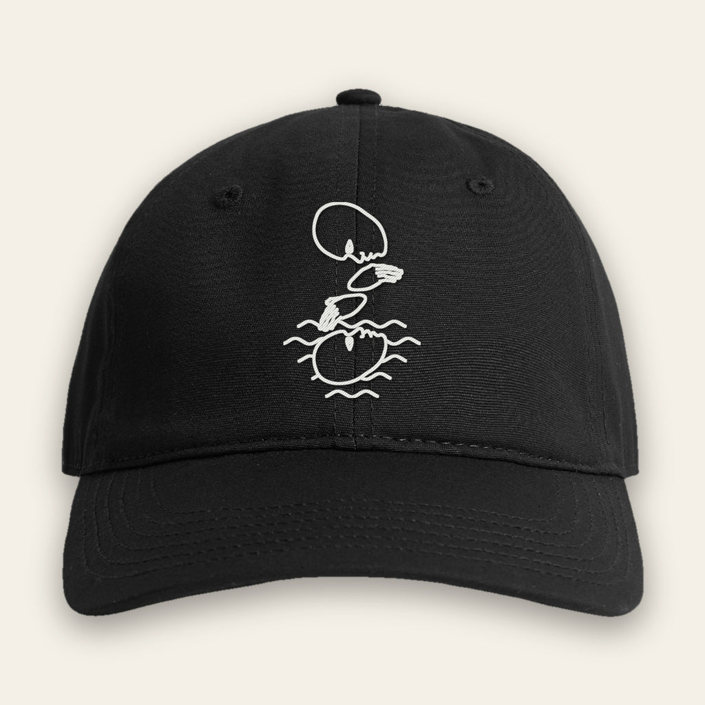 Black Unseen Worlds Mystery Logo cap with the white embroidered swimmer line drawing on the front