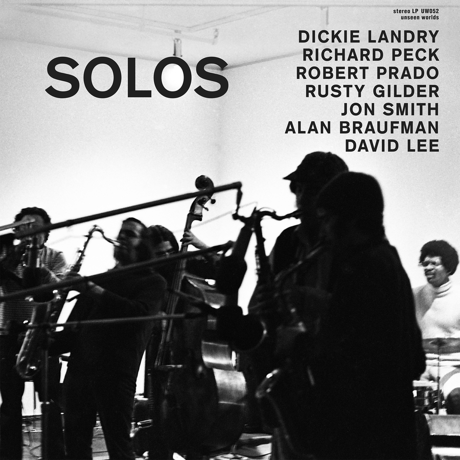 Album cover for Dickie Landry - Solos, a black-and-white photograph of musicians performing with saxophones and instruments in a rehearsal space